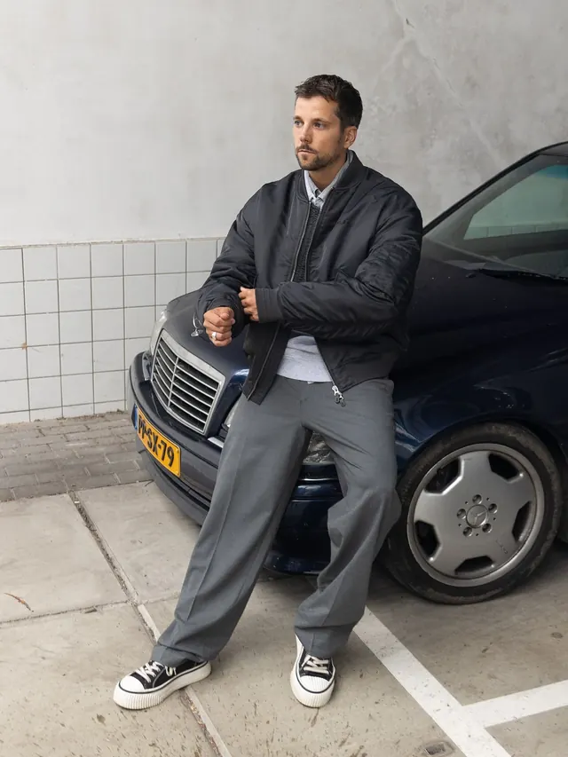 Street-style portrait with minimalist backdrop, photographic, monochrome