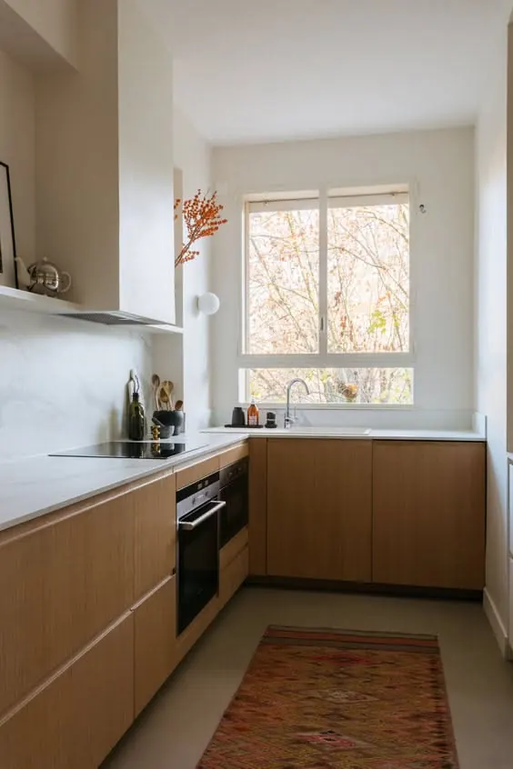 Warm minimalist kitchen with wood cabinetry, minimal, light-mode, warm