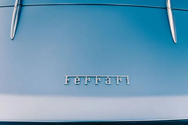 Ferrari Wordmark on Blue Surface, luxury, minimal, light