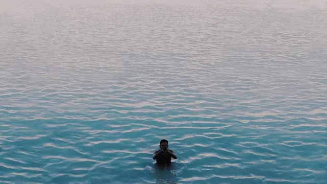 Person Floating in Blue Water, minimal, photographic, cool