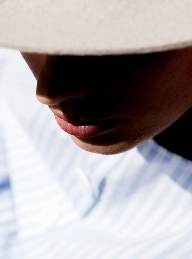Close-up Portrait with Hat, minimal, photographic, high-contrast