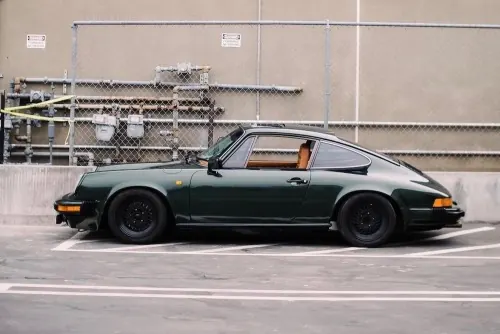 Vintage Porsche 911 in Industrial Setting, photographic, retro, dark