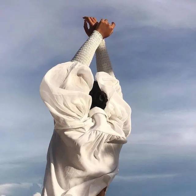 Person in White Oversized Garment, minimal, photographic, light