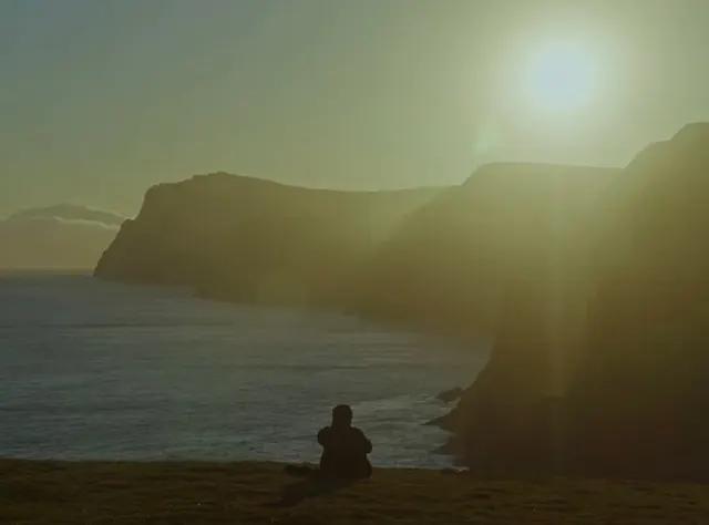 Person Sitting on Beach at Sunset, photographic, organic, warm