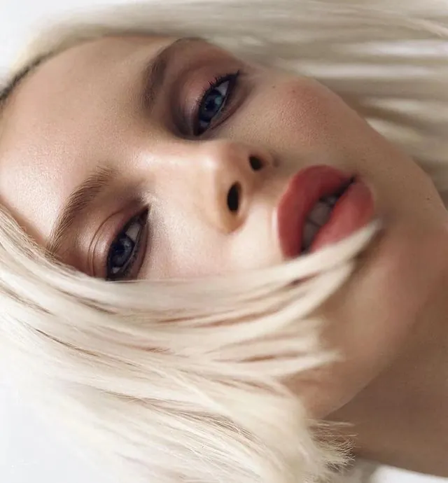 Close-up Portrait of a Woman with Blonde Hair, photographic, luxury, warm