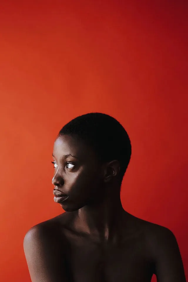 Portrait of a Black Woman against Red Background, minimal, photographic, vibrant
