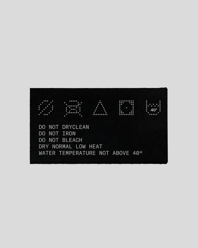 Laundry care label with dotted care symbols, minimal, technical, dark