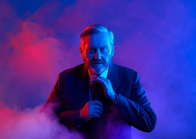 Man in Suit with Smoke and Dual Lighting, photographic, dark-mode, vibrant
