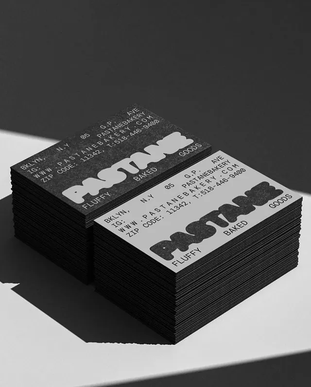 Monochrome business cards with oversized typography, minimal, corporate-clean, monochrome