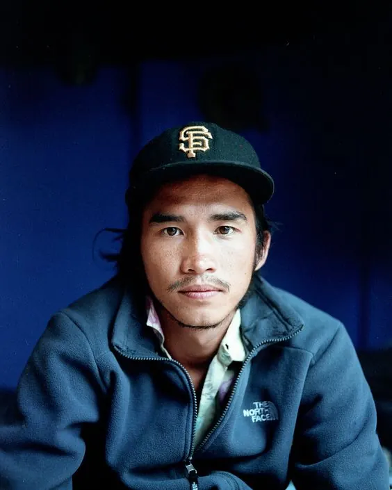 Portrait of a Man in a Baseball Cap, photographic, dark