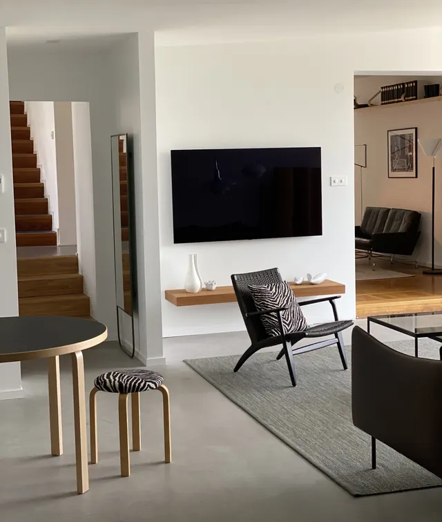 Modern living room interior with zebra-pattern seating, minimal, photographic, muted