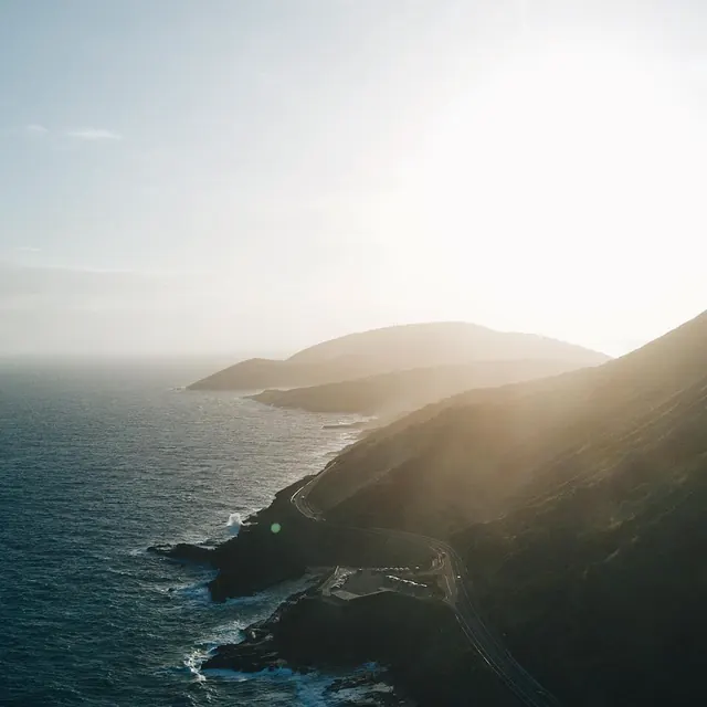Coastal Landscape with Sun Flare, photographic, organic, muted