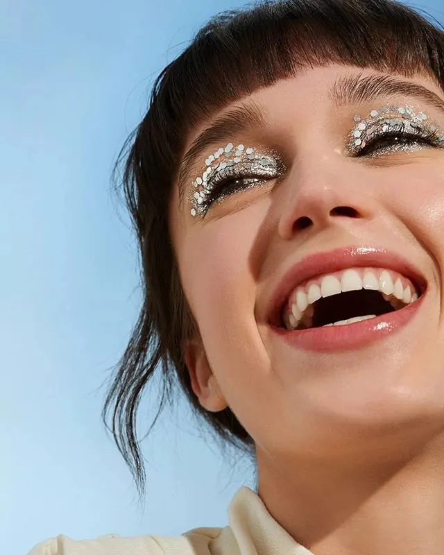 Close-up Portrait with Glitter Eye Makeup, photographic, maximalist, vibrant
