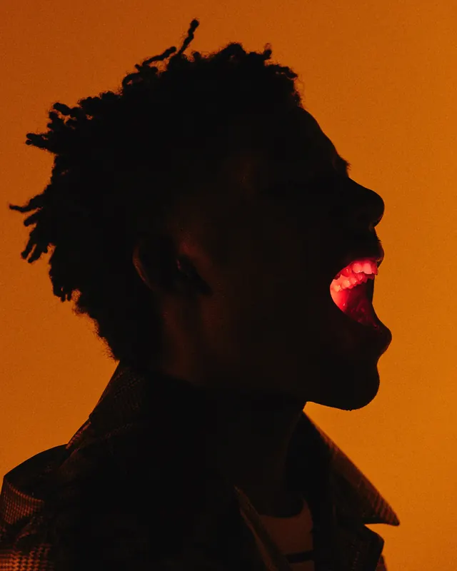 High-Contrast Portrait with Red Glow, photographic, vibrant