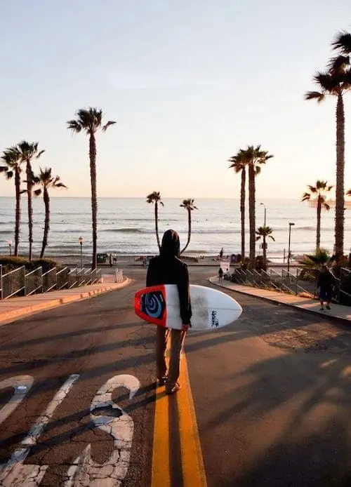 Beachfront Street Scene with Person and Sign, photographic, minimal, light