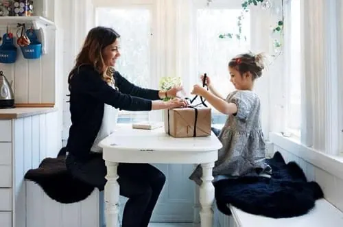 Woman and Child Sharing a Gift, photographic, organic, muted