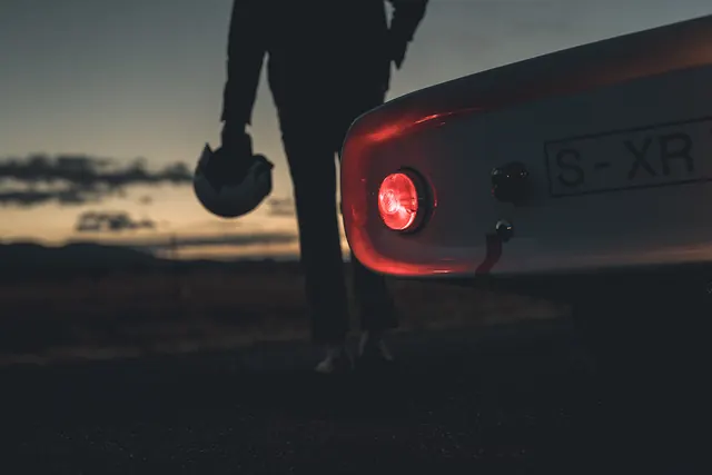 Person Standing Next to Car at Dusk, photographic, dark-mode, dark