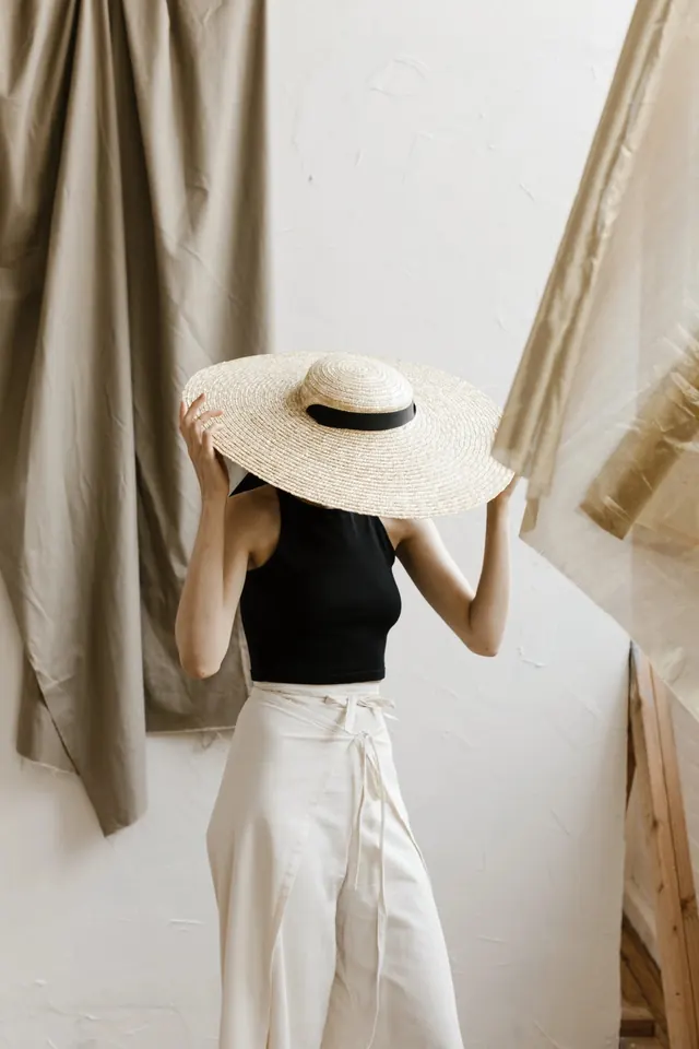 Woman in Straw Hat and White Trousers, minimal, photographic, muted