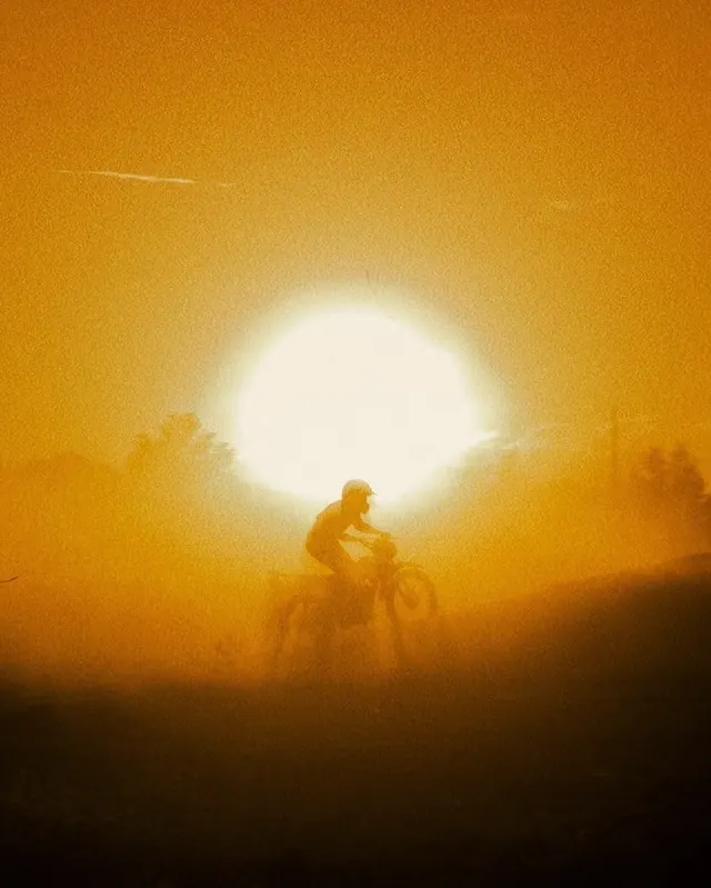 Silhouette of a Person on a Motorcycle in Golden Mist, photographic, organic, warm