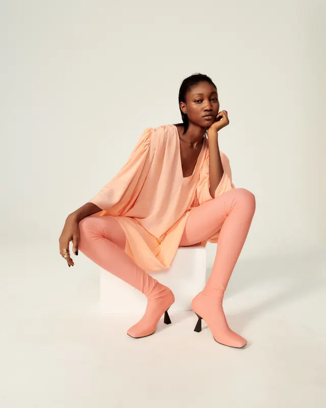 Model in Peach Tunic and Wide-Leg Trousers, minimal, photographic, warm