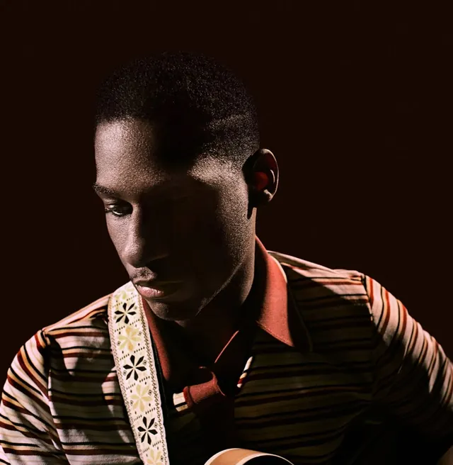 Portrait of a Man in Striped Shirt, photographic, dark-mode, dark