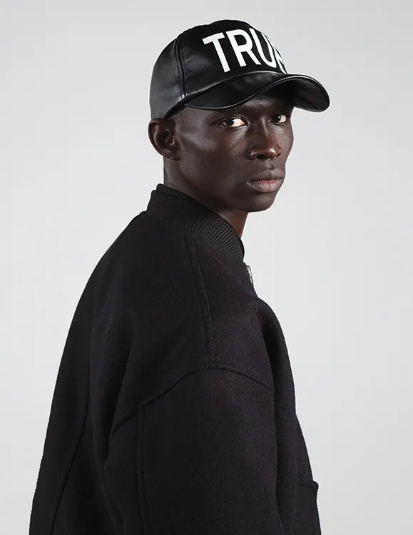Man Wearing Trucker Hat and Hoodie, minimal, monochrome, dark