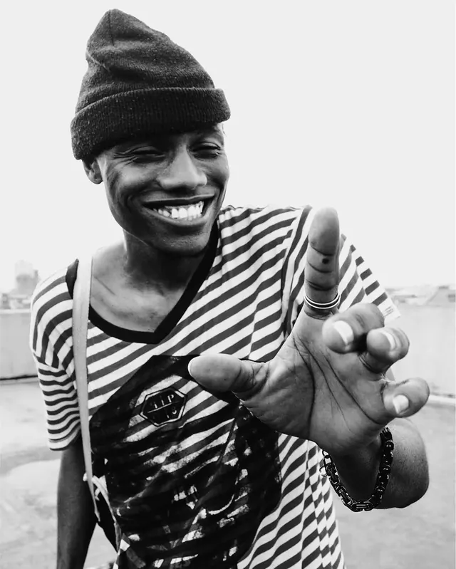 Smiling Man in Beanie and Striped Shirt, monochrome, photographic, monochrome