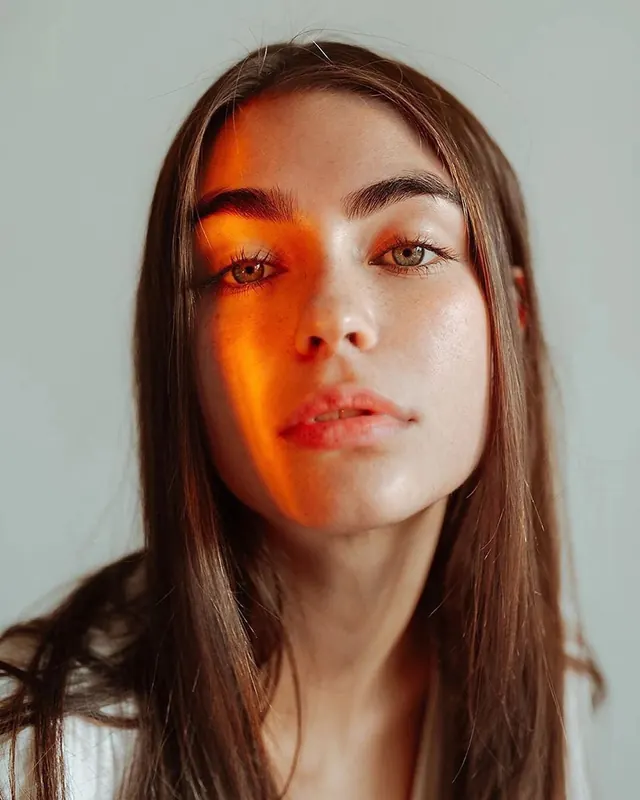 Portrait with Orange Light Projection, photographic, minimal, warm