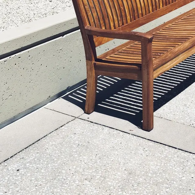 Wooden Bench on Concrete Surface, minimal, photographic, warm