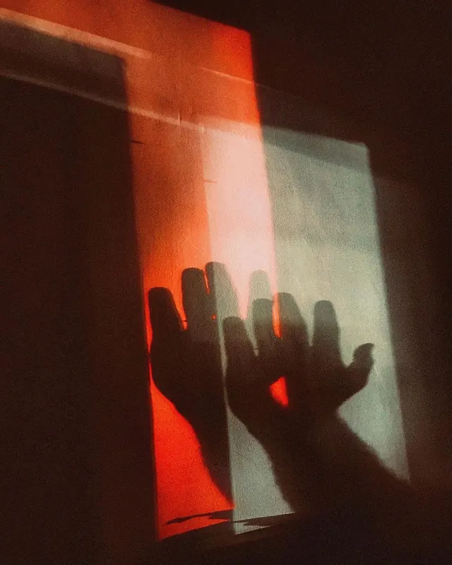 Shadowed Hands on Light Projection, abstract, photographic, high-contrast