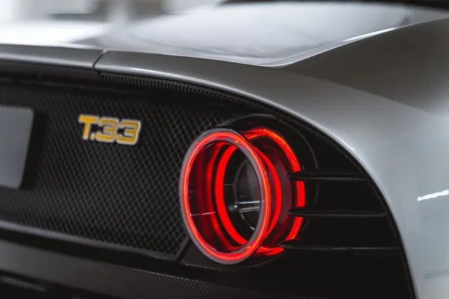 Car Rear Light and Badge Detail, photographic, luxury, dark