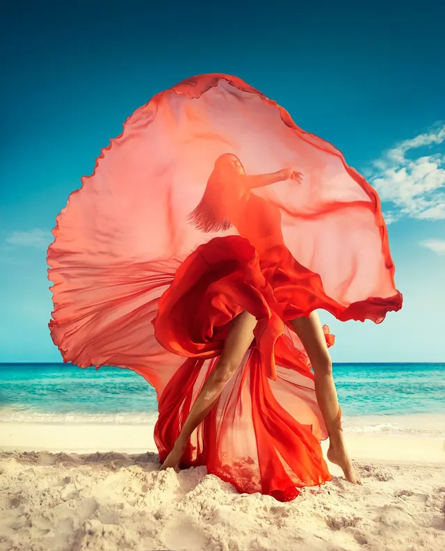 Woman in Flowing Red Dress on Beach, photographic, organic, vibrant