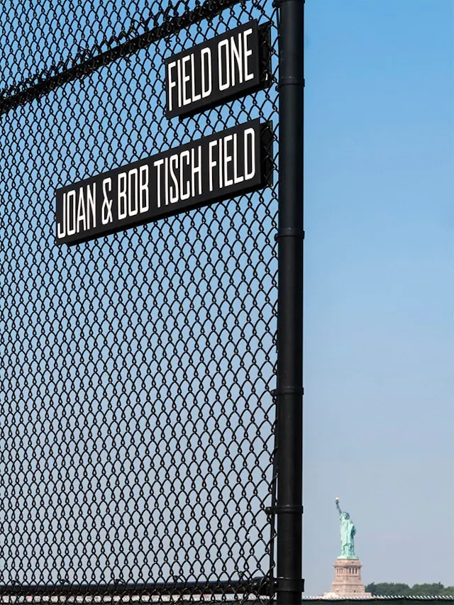 Field One Signage on Chain-Link Fence, minimal, photographic, high-contrast