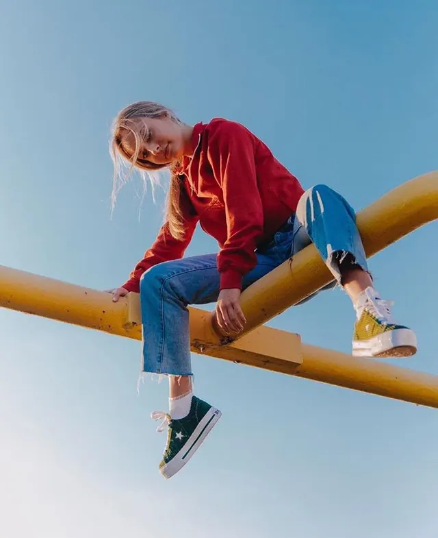 Person Balancing on Yellow Bar, photographic, minimal, vibrant