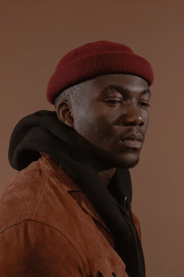 Portrait of a Man in a Beanie, photographic, minimal, warm