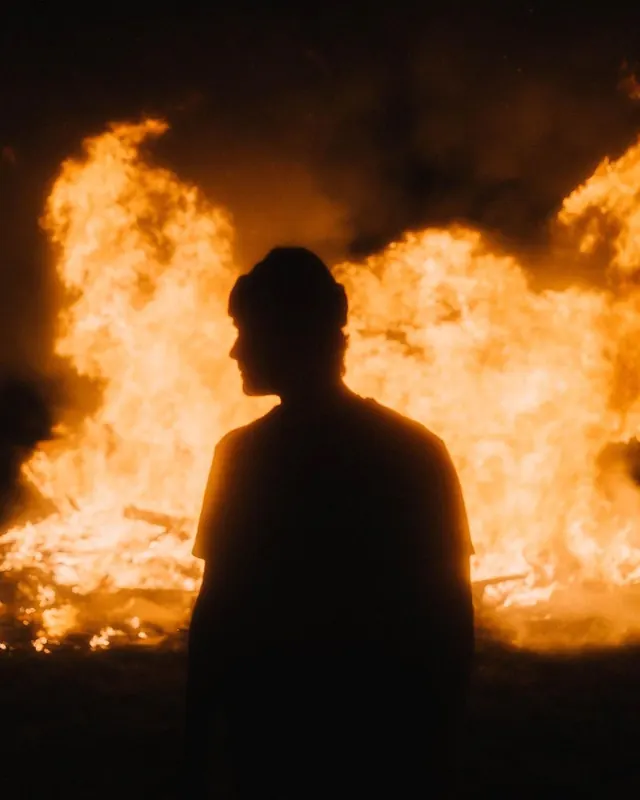 Man in Front of Fire, photographic, dark-mode, dark