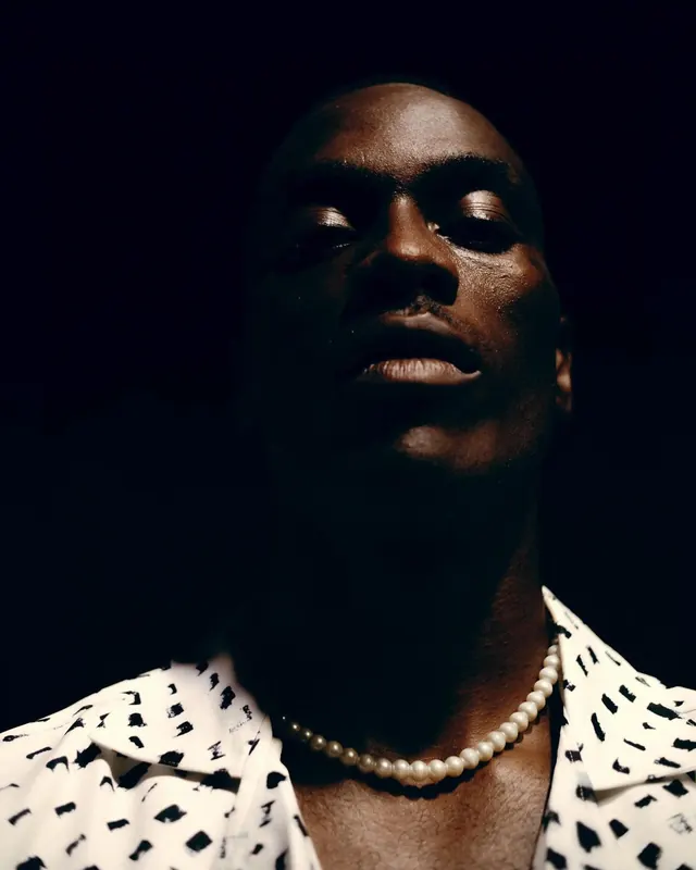 Portrait of a Man in Patterned Shirt, photographic, dark-mode, dark