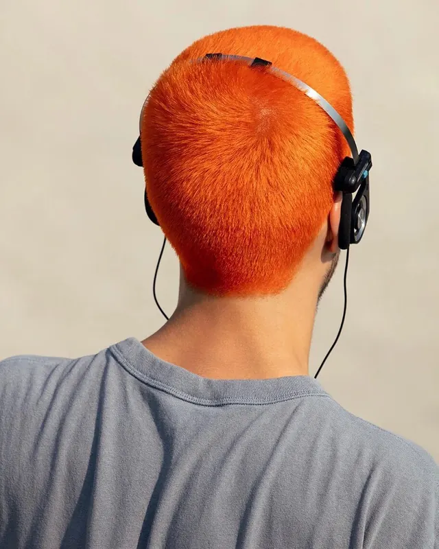Person with Orange Hair and Headphones, photographic, minimal, vibrant