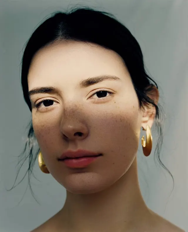 Portrait of a Woman with Gold Earrings, photographic, minimal, muted