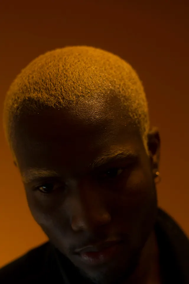 Portrait of a Man with Blonde Buzz Cut, photographic, minimal, warm