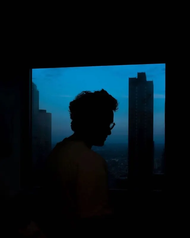Silhouette of a Person in a Cityscape, dark-mode, photographic, dark