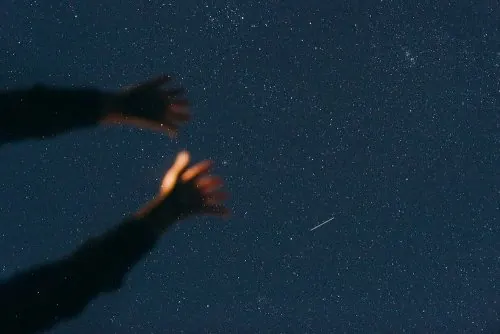 Hand Holding a Glowing Flame, dark-mode, photographic, dark