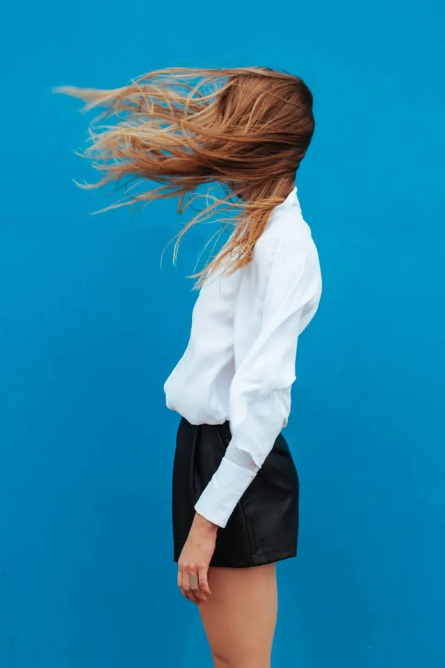 Woman with Wind-Swept Hair, photographic, minimal, vibrant