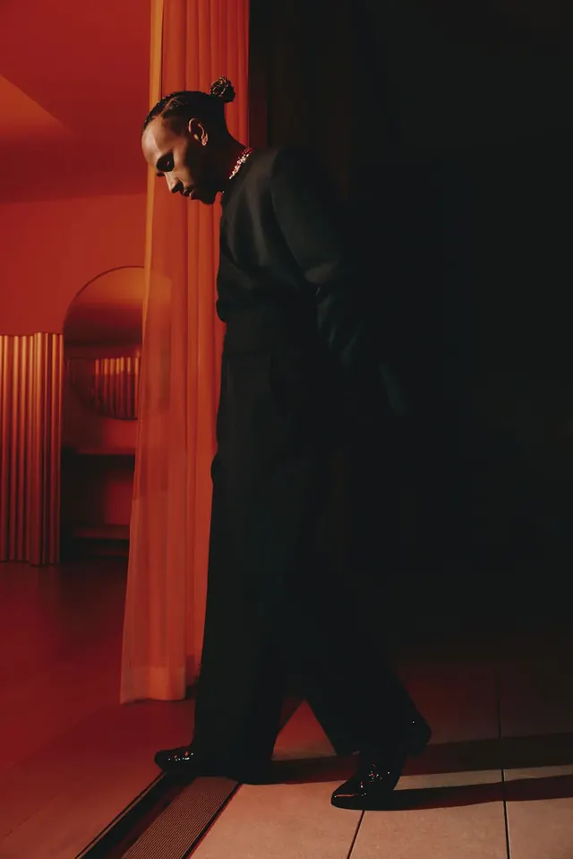 Man in Suit Standing in Red Lit Room, photographic, dark-mode, dark