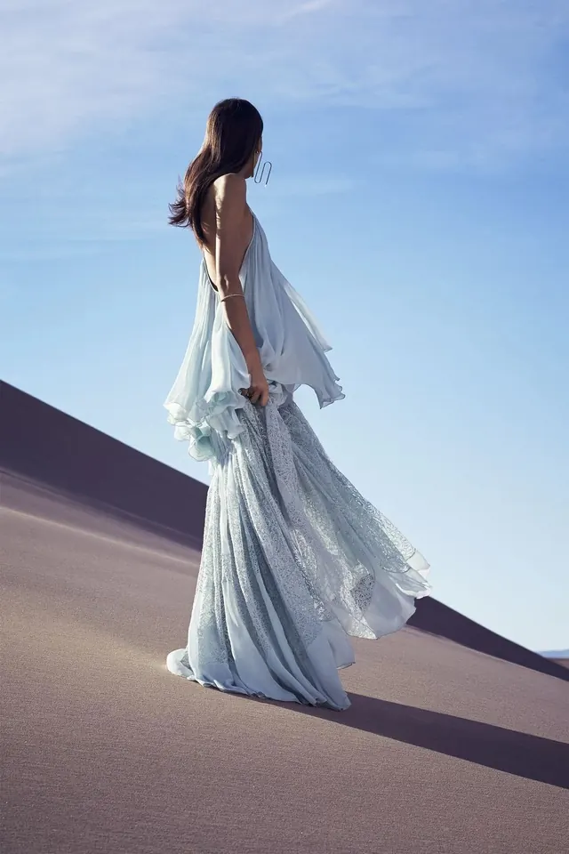Woman in Flowing Blue Gown on Sand Dune, photographic, luxury, light
