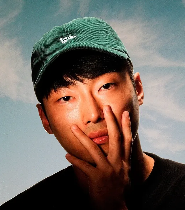 Portrait of a Man in a Green Cap, photographic, minimal, vibrant