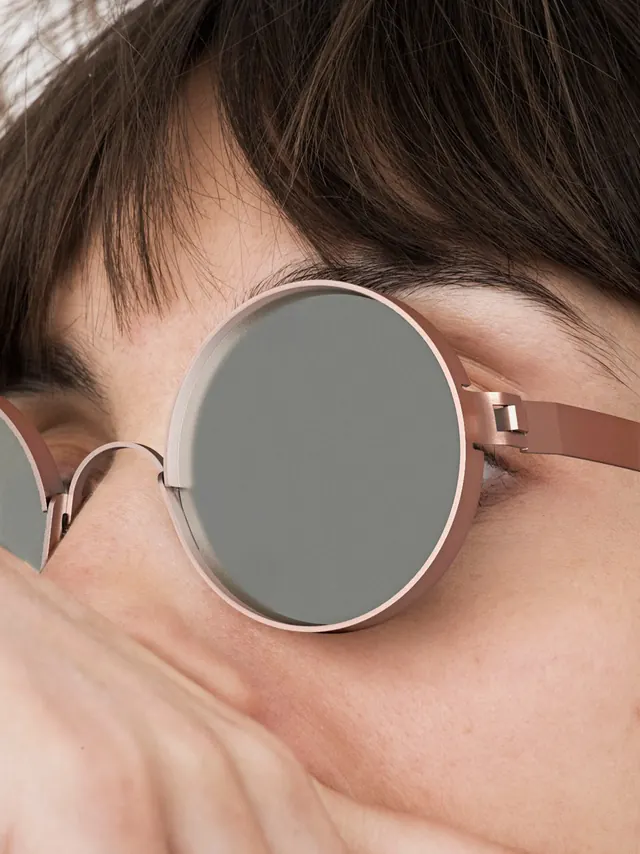 Close-up of Person Wearing Round Sunglasses, photographic, minimal, muted