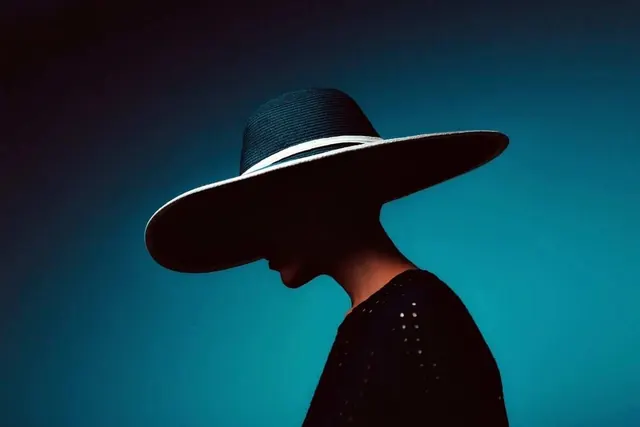 Profile of Person in Wide-Brimmed Hat, minimal, photographic, dark