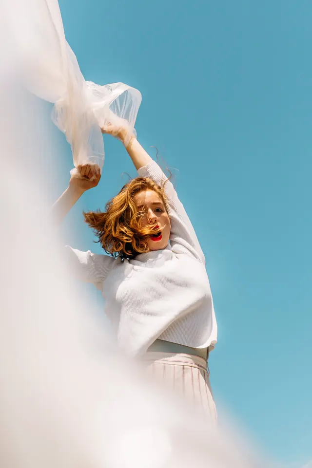 Woman in White Dress Against Blue Sky, photographic, minimal, light