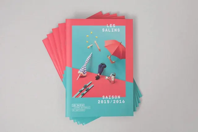 Les Salins season program booklet stack, minimal, editorial, vibrant